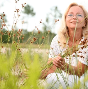 Smiling woman relaxing outdoors in a field in Frederick, MD