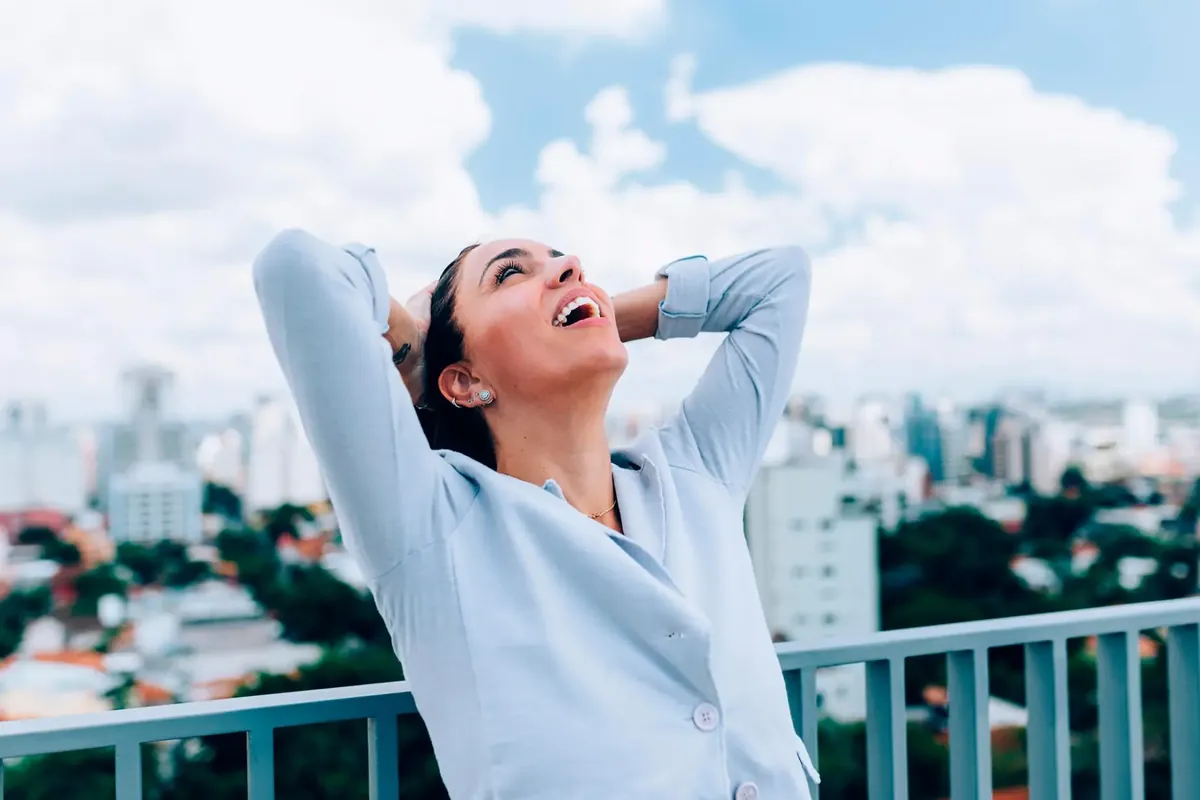 Woman outdoors enjoying relief from migraine headaches