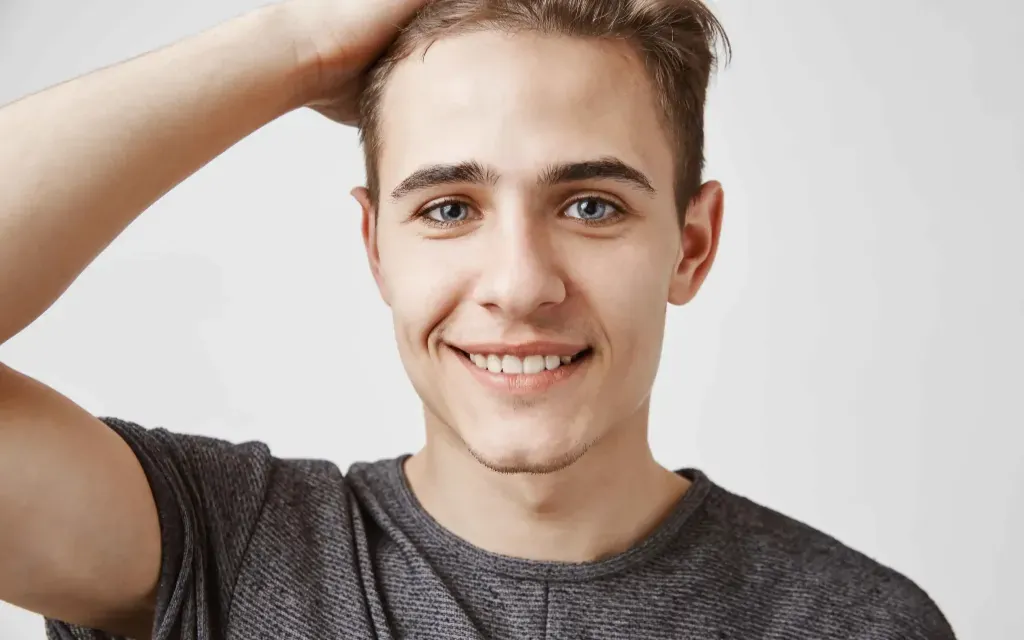 Smiling young man, representing relief from shingles nerve pain