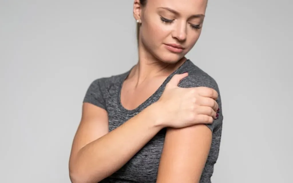 Woman holding a sore shoulder