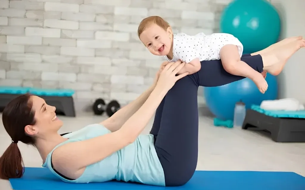 Mother lifting her smiling baby during a playful moment, representing Life Fertility BioTherapy